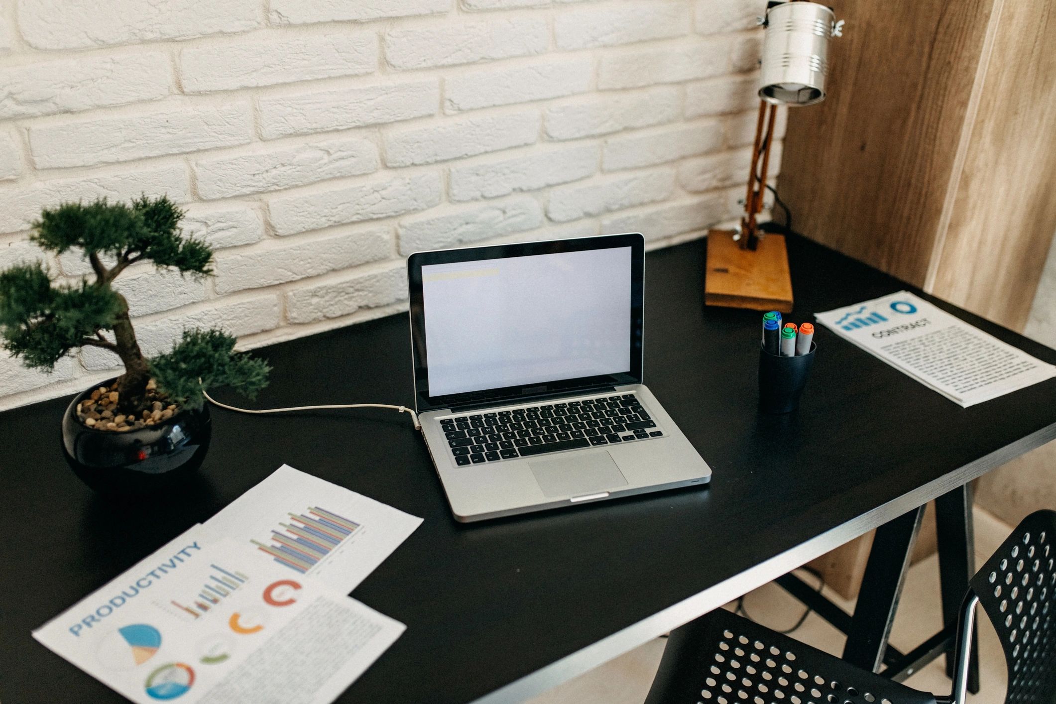 Travel planning desk with laptop and documents