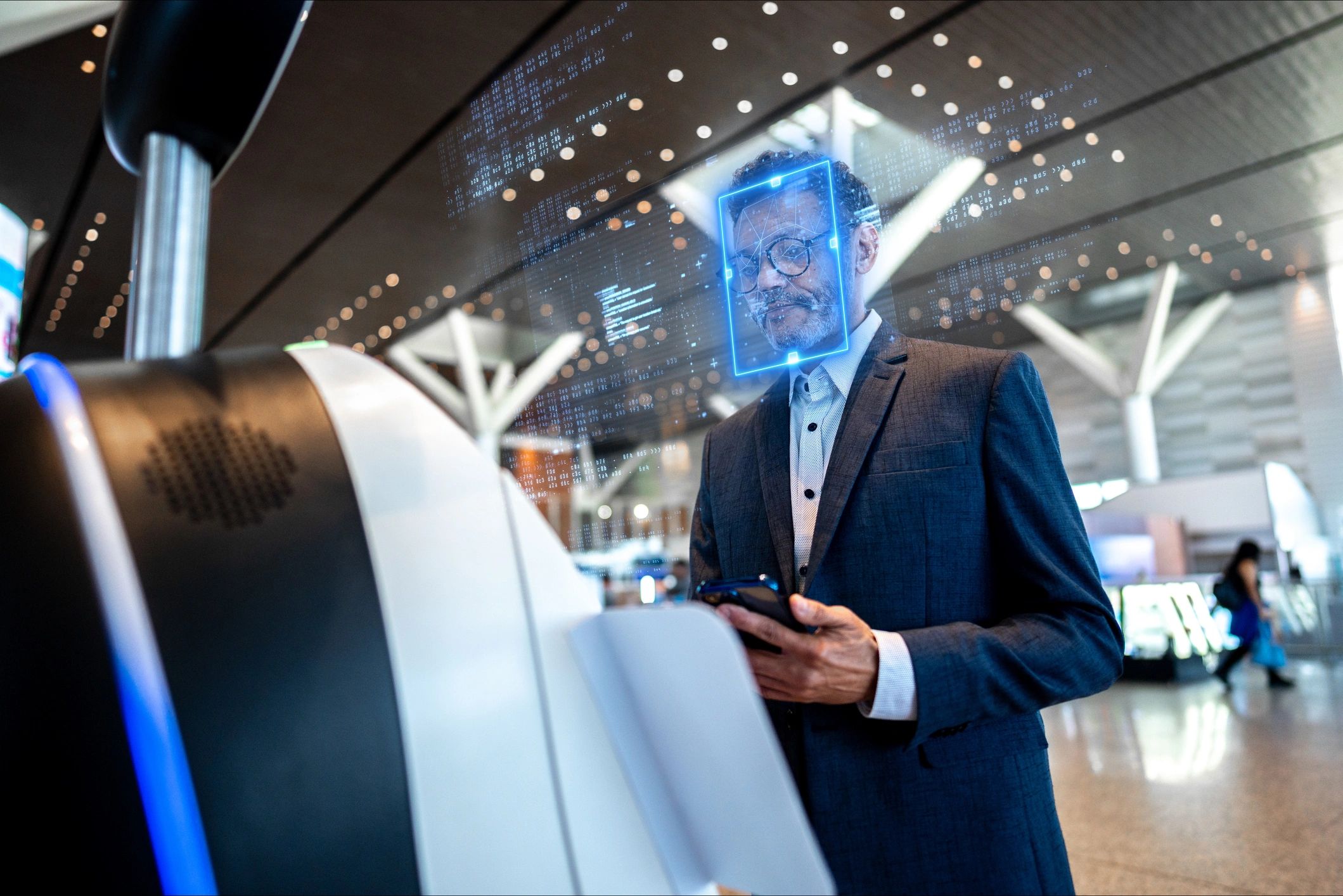 Business traveler using modern airport check-in technology