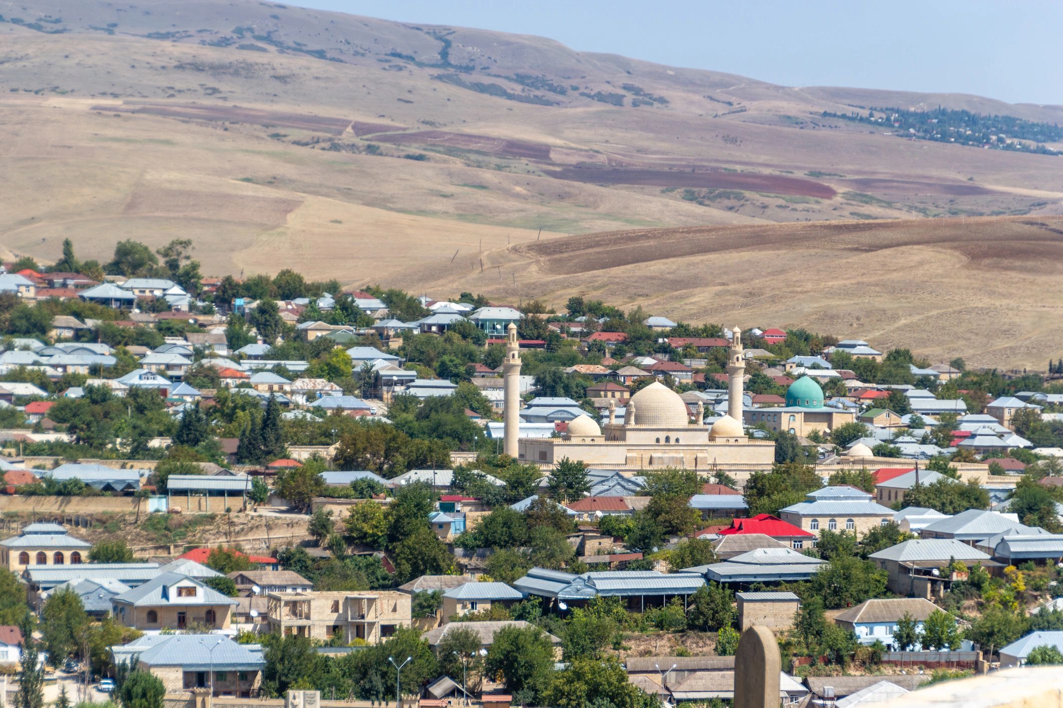 Panoramic view of an Azerbaijan town with mosque and hills