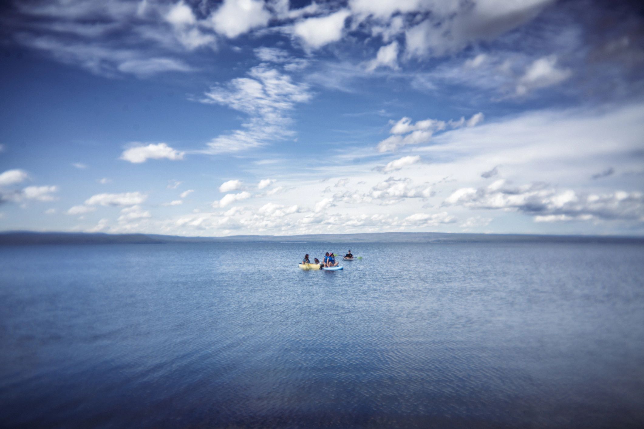 Travelers kayaking on a scenic lake