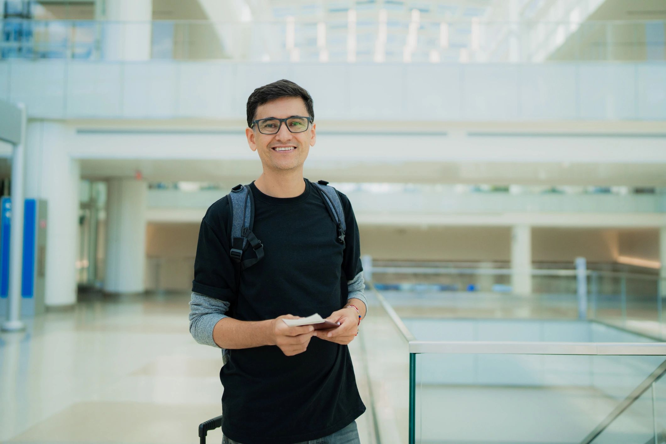Traveler holding passport in airport terminal