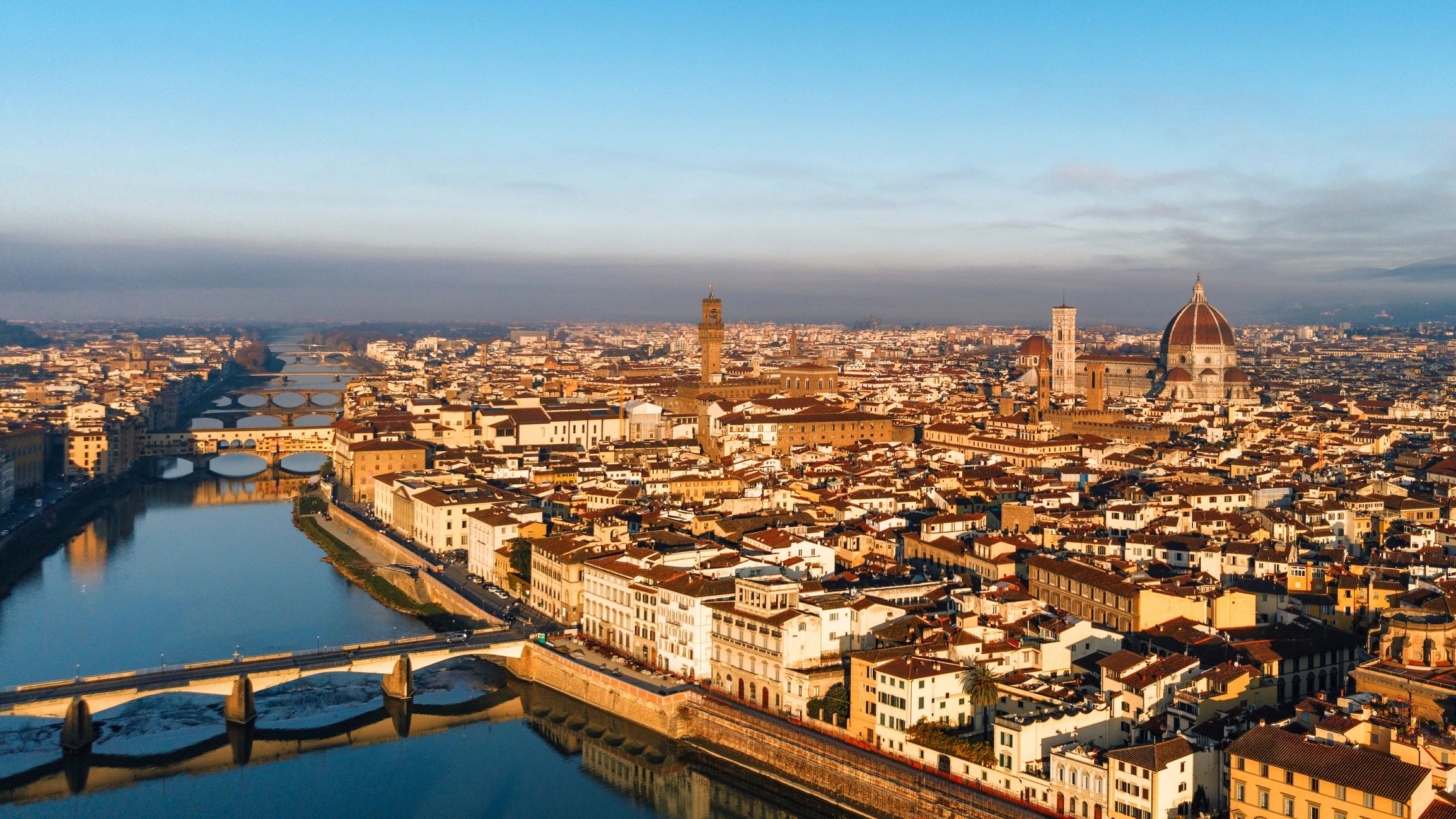 Florence cityscape with Duomo and Arno river at sunrise