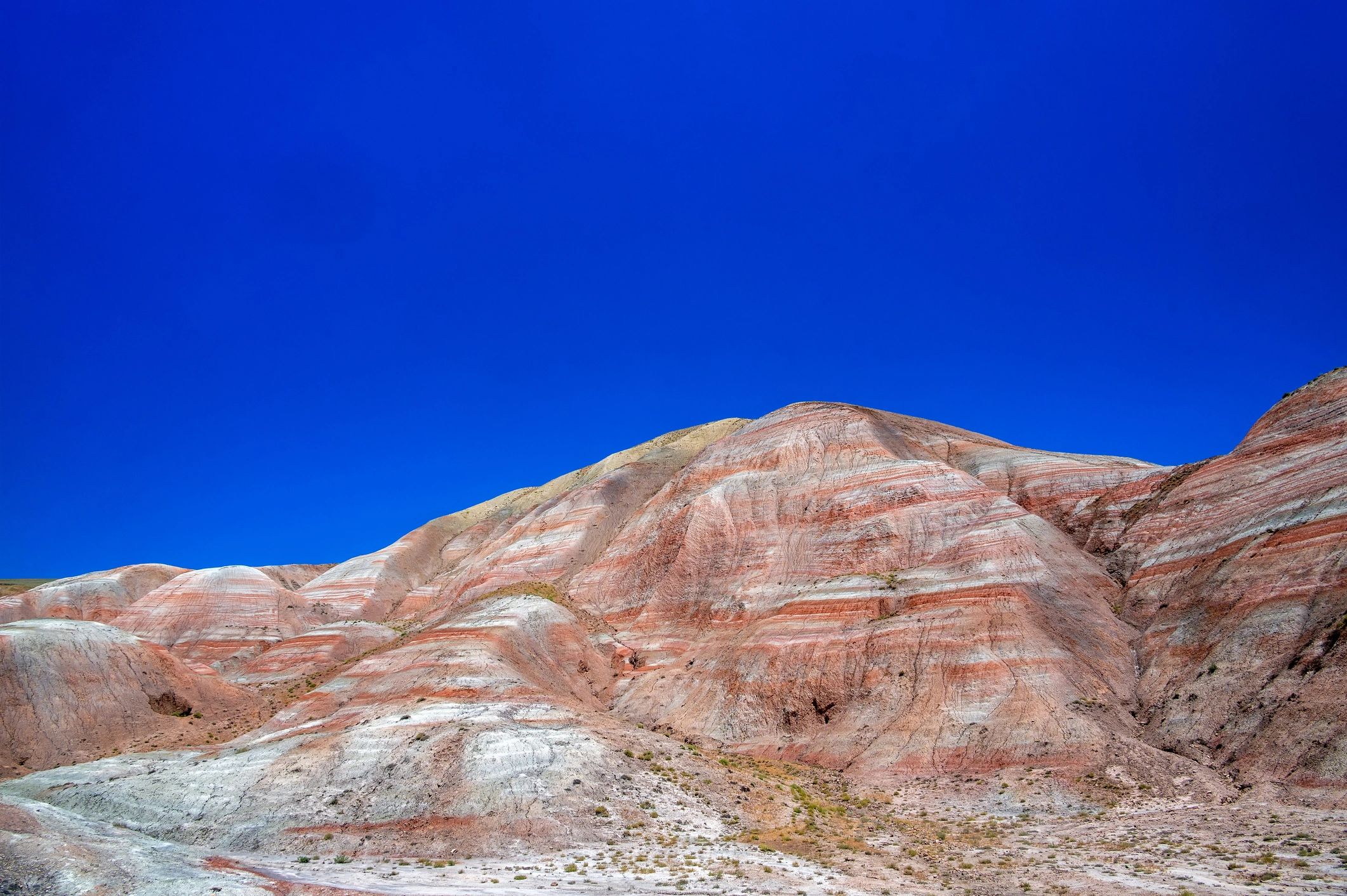 Azerbaijan Candy Cane Mountains displaying geological layers under blue sky