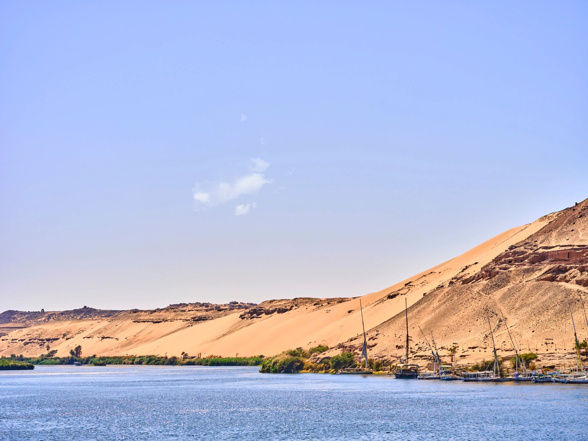 Traditional felucca sailboats along the Nile riverbank in Egypt